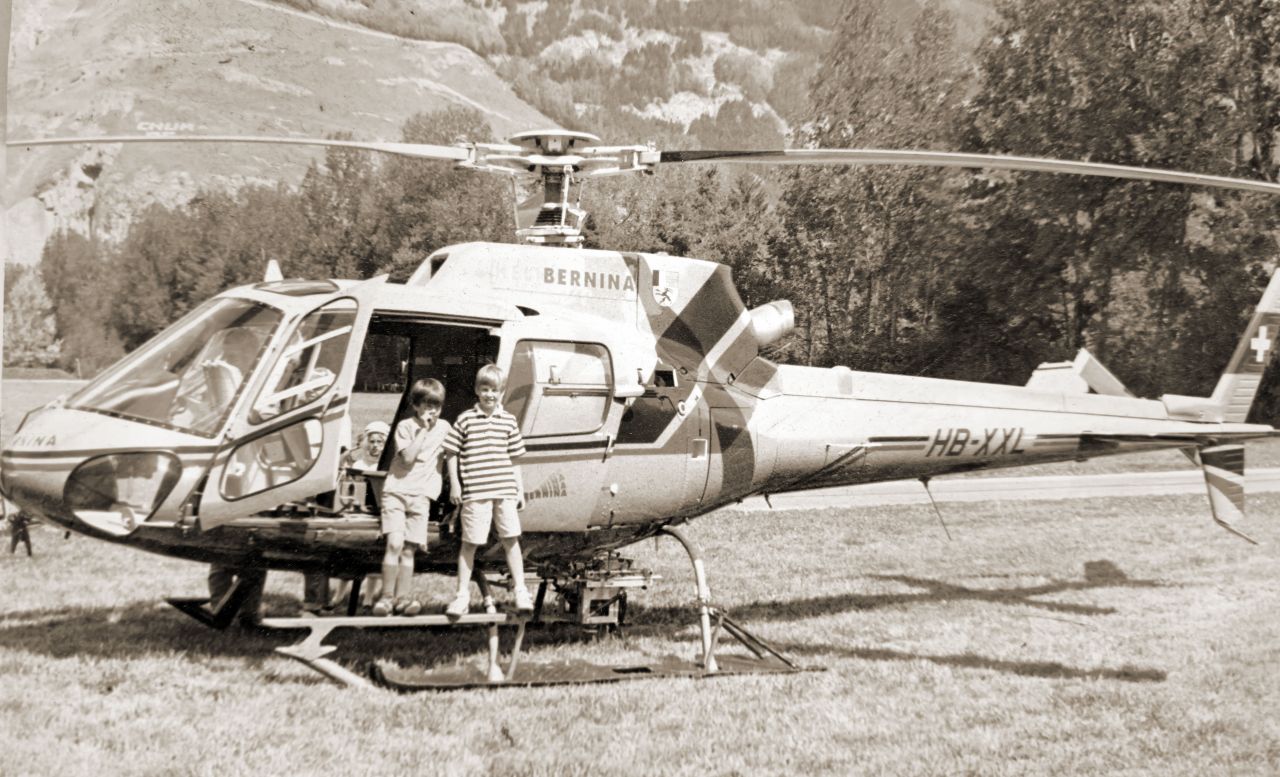 The two founders of Geotrend GmbH in front of a helicopter with an aerial camera system.