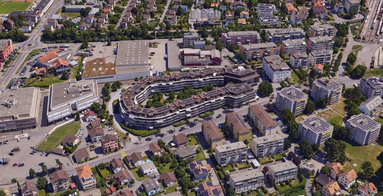 Texturiertes 3D-Mesh eines Wohnquartiers mit geschwungener Wohnüberbauung, Gewerbebauten und Gleisfeld